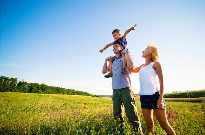 a family enjoying the outdoors in a field